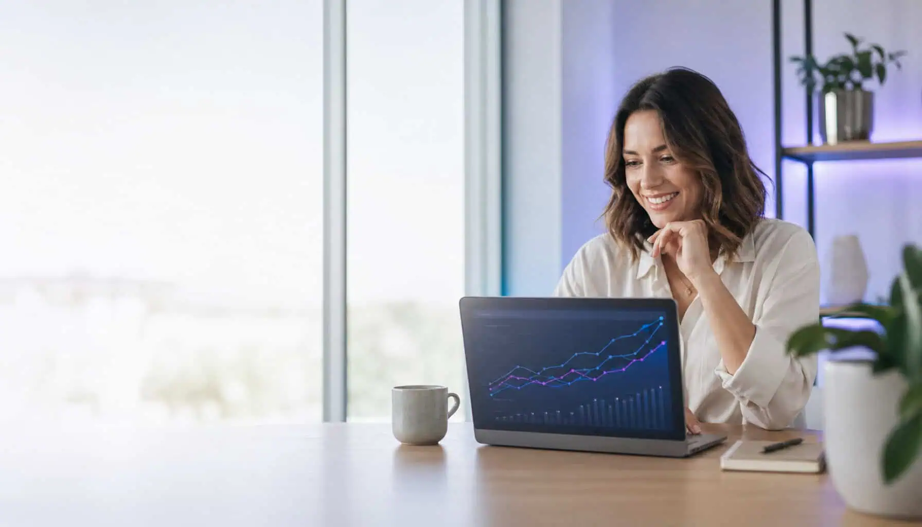 A small business owner smiling at a laptop showing steadily rising search performance graphs