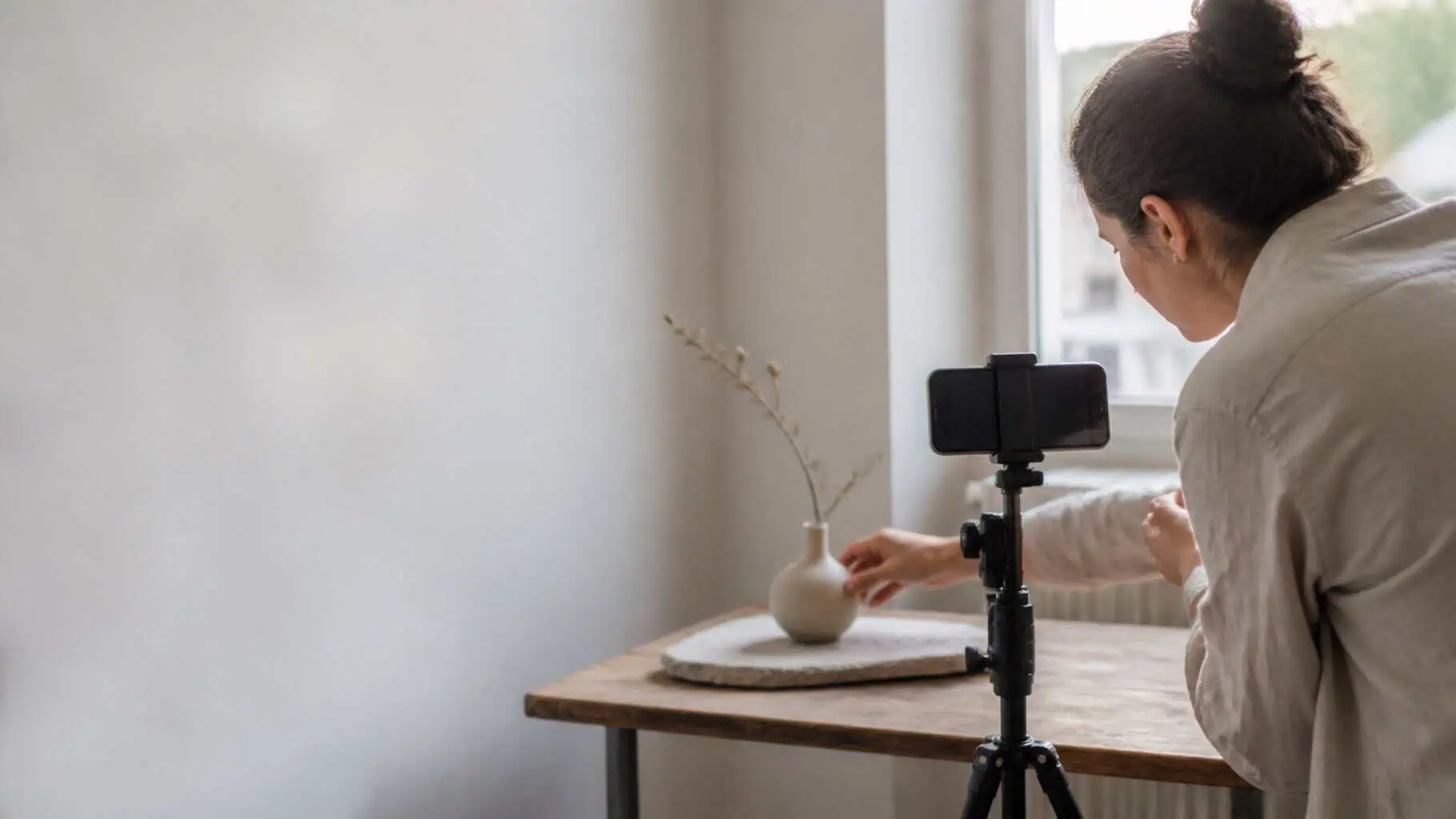 A business owner photographing a product on a small tabletop setup